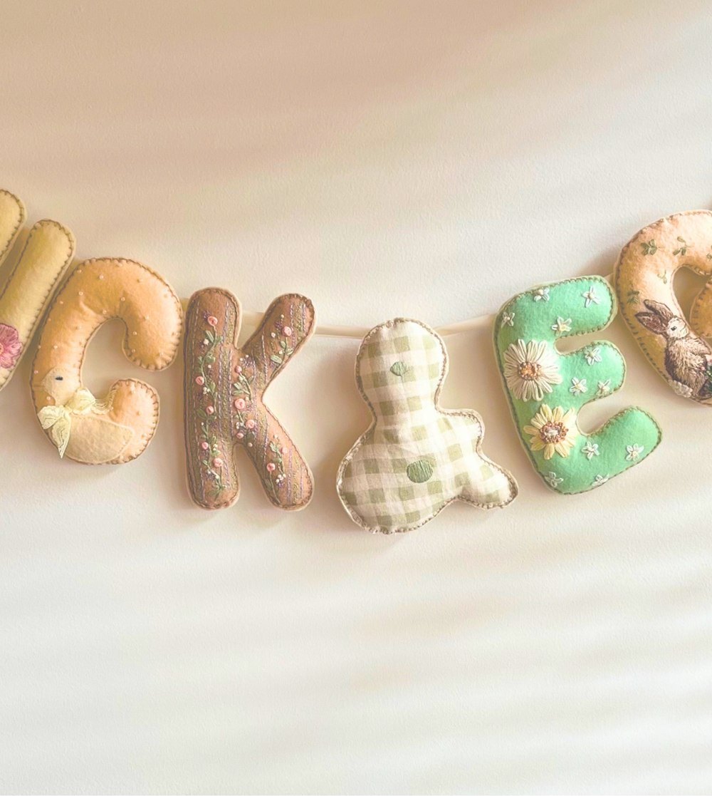 A felt banner spelling DUCK & EGG hung on a wall