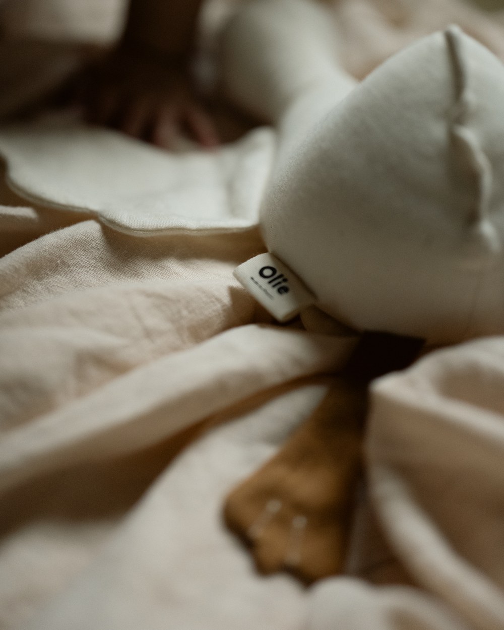 The Olie label stitched into the seam of the linen goose